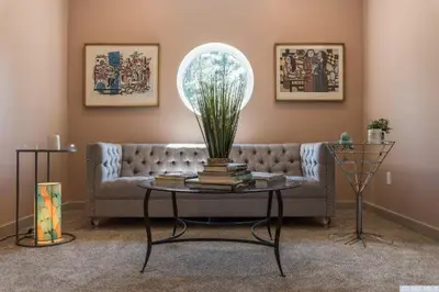 a living room with a couch and a table with books at Spencertown Inn in Spencertown