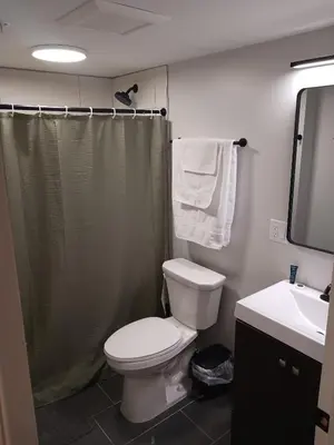 a bathroom with a toilet and a shower and a sink at Fully Furnished Studio Wifi GYM Free Parking in Hartford