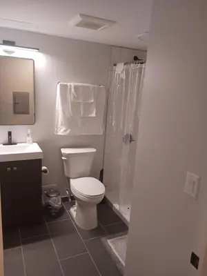 a bathroom with a toilet and a shower and a sink at Fully Furnished Studio Wifi GYM Free Parking in Hartford