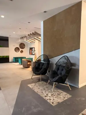 two black chairs sitting in a lobby at Fully Furnished Studio Wifi GYM Free Parking in Hartford