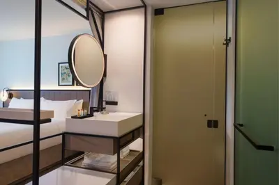 a bathroom with a sink and a mirror at Renaissance New York Flushing Hotel at Tangram in Queens