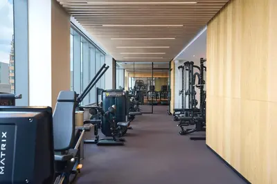 a gym with a row of treadms and machines at Renaissance New York Flushing Hotel at Tangram in Queens