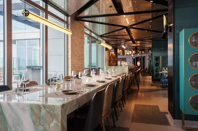 a long dining room with a long table with chairs at Renaissance New York Flushing Hotel at Tangram in Queens