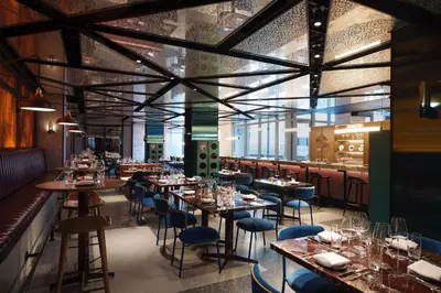 a restaurant with tables and chairs and a bar at Renaissance New York Flushing Hotel at Tangram in Queens