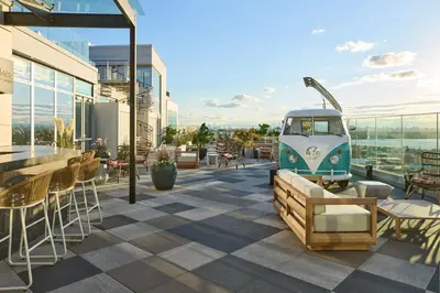 a rooftop patio with tables and chairs on a building at Renaissance New York Flushing Hotel at Tangram in Queens