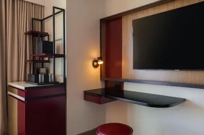 a hotel room with a flat screen tv on the wall at Renaissance New York Flushing Hotel at Tangram in Queens