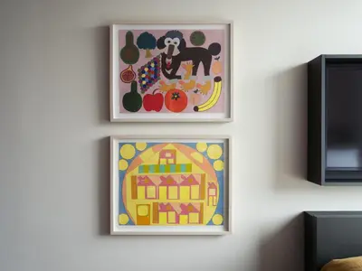 two framed paintings of a dog and fruit on a wall at Penny Williamsburg in Brooklyn