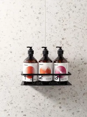 a shelf with four bottles of detergent on a wall at Penny Williamsburg in Brooklyn