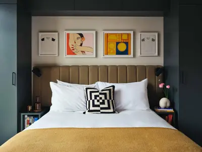 a bedroom with a bed and some pictures on the wall at Penny Williamsburg in Brooklyn