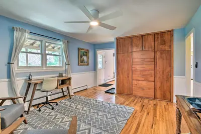 a living room with a desk and a ceiling fan at Decked-Out Home Hot Tub, Pool, Fire Pit and More! in Monroe