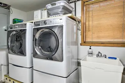 a washer and dryer in a kitchen with a sink at Decked-Out Home Hot Tub, Pool, Fire Pit and More! in Monroe