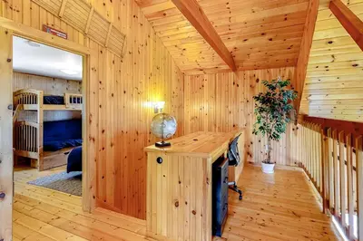 a wooden room with a desk in a cabin at Swaying Pines in Wilmington