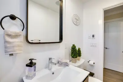 a bathroom with a white sink and a mirror at Lovely Highland Home with Pool and Hot Tub! in Highland