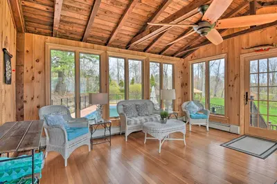 a living room with chairs and a ceiling fan at Lovely Highland Home with Pool and Hot Tub! in Highland