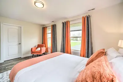 a bedroom with a bed and a chair and a window at Modern-Chic Athens Home - Fish, Ski and Swim! in Athens