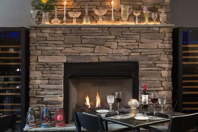 a fireplace with a table in front of it at Hotel Anthracite in Carbondale