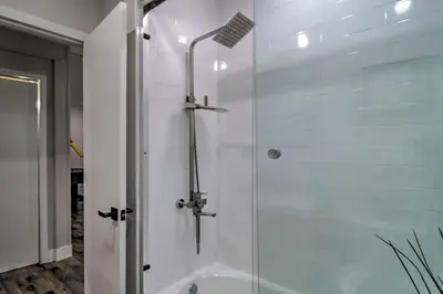 a shower with a glass door in a bathroom at 6 Mi to Camelback Slopes! Home with Game Room in Long Pond