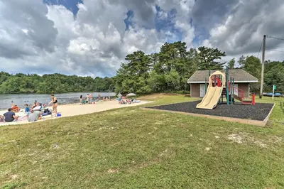 a playground with a slide and people on a beach at 6 Mi to Camelback Slopes! Home with Game Room in Long Pond