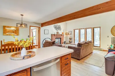 a kitchen and living room with a couch at Private Spa, Fire Pit and Deck Poconos Home! in Long Pond