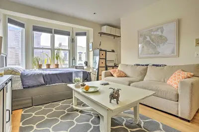 a living room with a couch and a table at Hoboken Studio Near Dining about 15 Min to NYC! in Hoboken