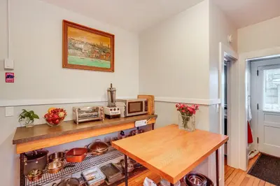 a kitchen with a table and a microwave at Elegant Pittsfield Home Near Downtown and Skiing! in Pittsfield