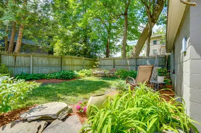 a yard with two chairs and a fence at Elegant Pittsfield Home Near Downtown and Skiing! in Pittsfield