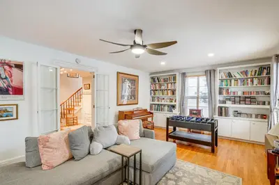 a living room with a couch and a piano at Elegant Pittsfield Home Near Downtown and Skiing! in Pittsfield