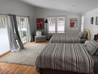 a living room with two beds and a couch at Beautiful Charming Cottage 4 min from Woodstock in Woodstock