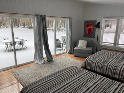 a bedroom with a bed and a view of a patio at Beautiful Charming Cottage 4 min from Woodstock in Woodstock