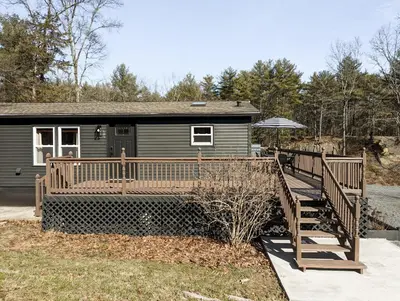 a home with a wooden ramp leading to a house at Pinewood Bungalow - Luxury Cabin, Kid-Friendly in Catskill