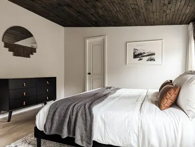 a bedroom with a bed with a wooden ceiling at Pinewood Bungalow - Luxury Cabin, Kid-Friendly in Catskill