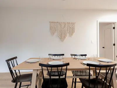 a dining room with a wooden table and chairs at Pinewood Bungalow - Luxury Cabin, Kid-Friendly in Catskill