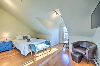 a bedroom with a bed and a chair at half Mi to Windham Mtn Main Street Condo in Windham