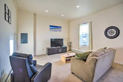 a living room with two couches and a tv at half Mi to Windham Mtn Main Street Condo in Windham