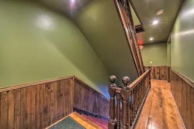 a wooden staircase in a house with green walls at half Mi to Windham Mtn Main Street Condo in Windham