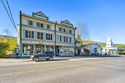 a car parked in front of a building on a street at half Mi to Windham Mtn Main Street Condo in Windham