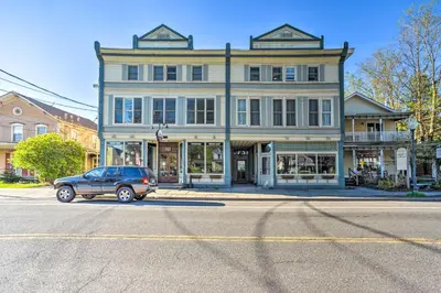 a car parked in front of a large building at half Mi to Windham Mtn Main Street Condo in Windham