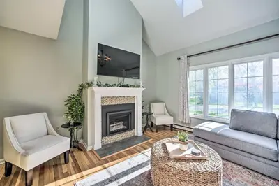 a living room with a couch and a fireplace at Family-Friendly Retreat with Hot Tub 1 Mi to Dtwn in Saratoga Springs