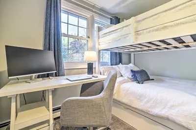 a bedroom with a computer desk and bunk beds at Family-Friendly Retreat with Hot Tub 1 Mi to Dtwn in Saratoga Springs
