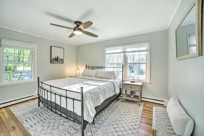 a bedroom with a bed and a ceiling fan at Family-Friendly Retreat with Hot Tub 1 Mi to Dtwn in Saratoga Springs