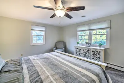 a bedroom with a bed and a ceiling fan at Family-Friendly Retreat with Hot Tub 1 Mi to Dtwn in Saratoga Springs