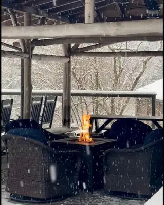 a fire pit on a patio in the snow at The Blue House On The Hill Catskills—Views in Claryville