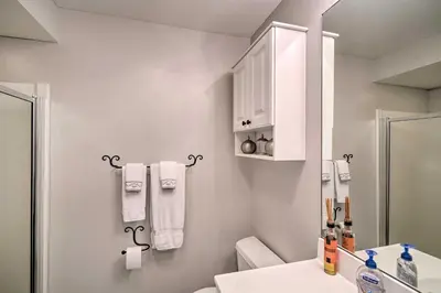 a white bathroom with a sink and a mirror at Family-Friendly Hancock Home Walk to Slopes! in Hancock