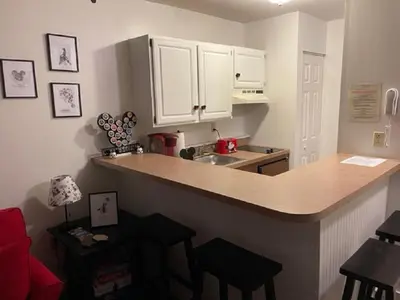 a kitchen with white cabinets and a counter top at Disney Magic at Jiminy Mountain in Hancock