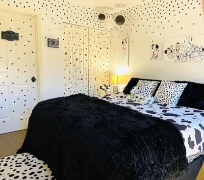 a bedroom with a black and white comforter on a bed at Disney Magic at Jiminy Mountain in Hancock