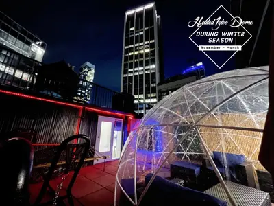 a clear umbrella sitting on top of a patio at Hotel and the City, Rooftop City View in New York