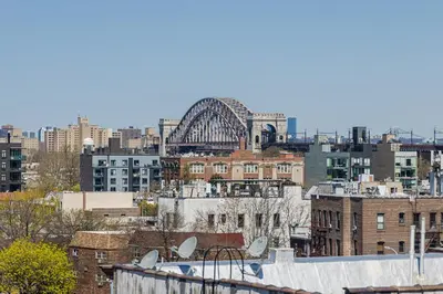 a view of a city with a bridge in the background at Astoria Inn LaGuardia Hotel in Queens