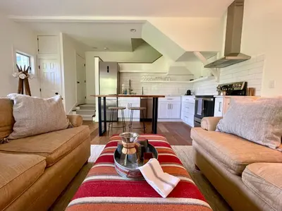 a living room with two couches and a table at Hill Farm Inn - Manchester in Sunderland