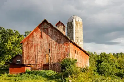 an old red barn with a silo on top of it at Hill Farm Inn - Manchester in Sunderland