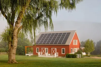 a red barn with solar panels on the roof at Hill Farm Inn - Manchester in Sunderland